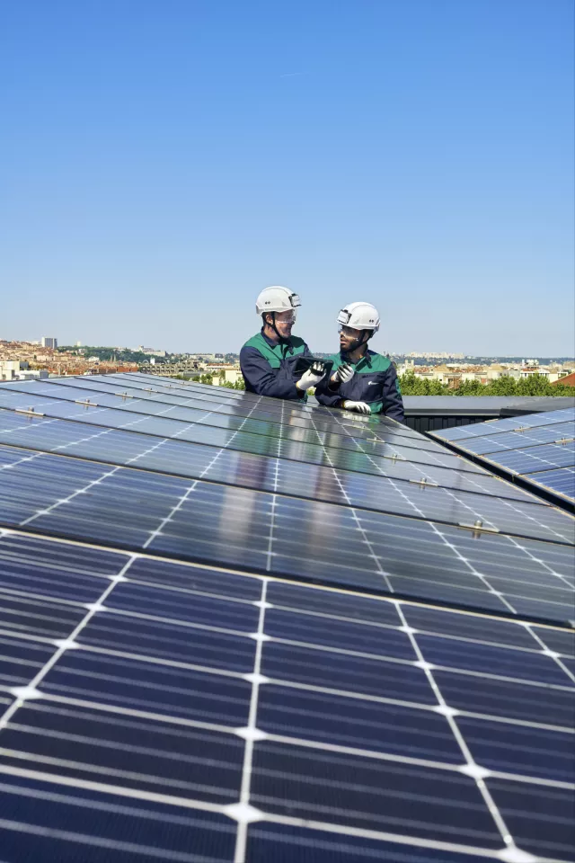  deux ouvriers du bâtiment derrière des panneaux solaires